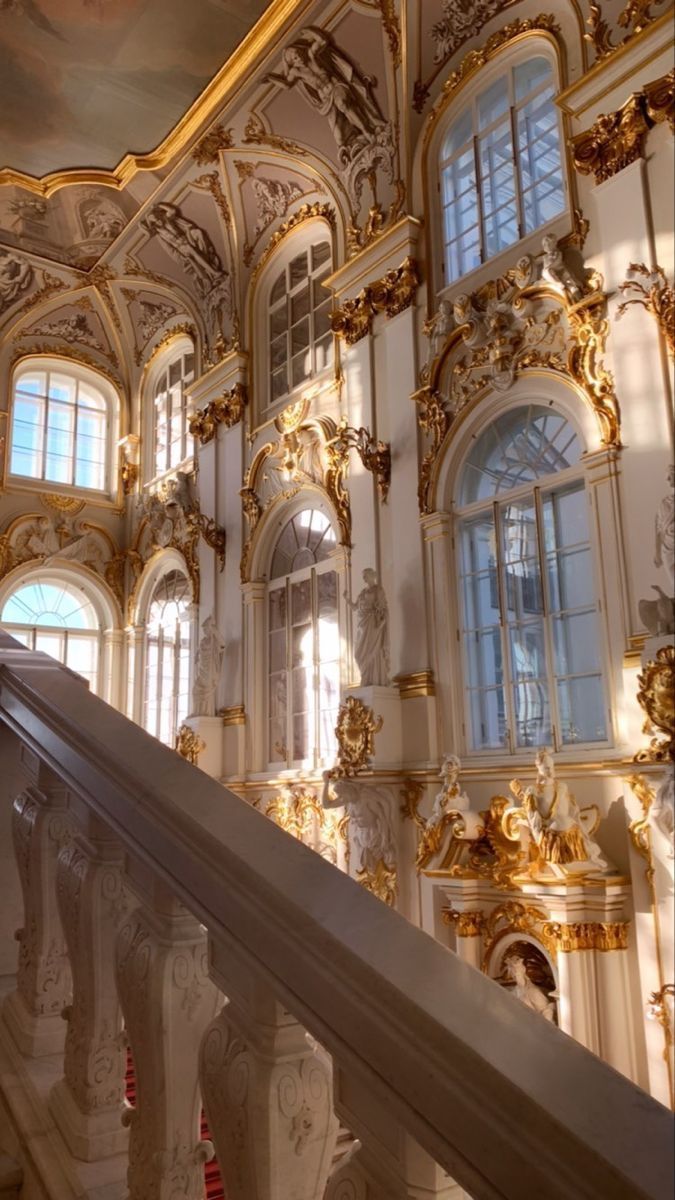 A staircase with gold decorations and windows - Castle