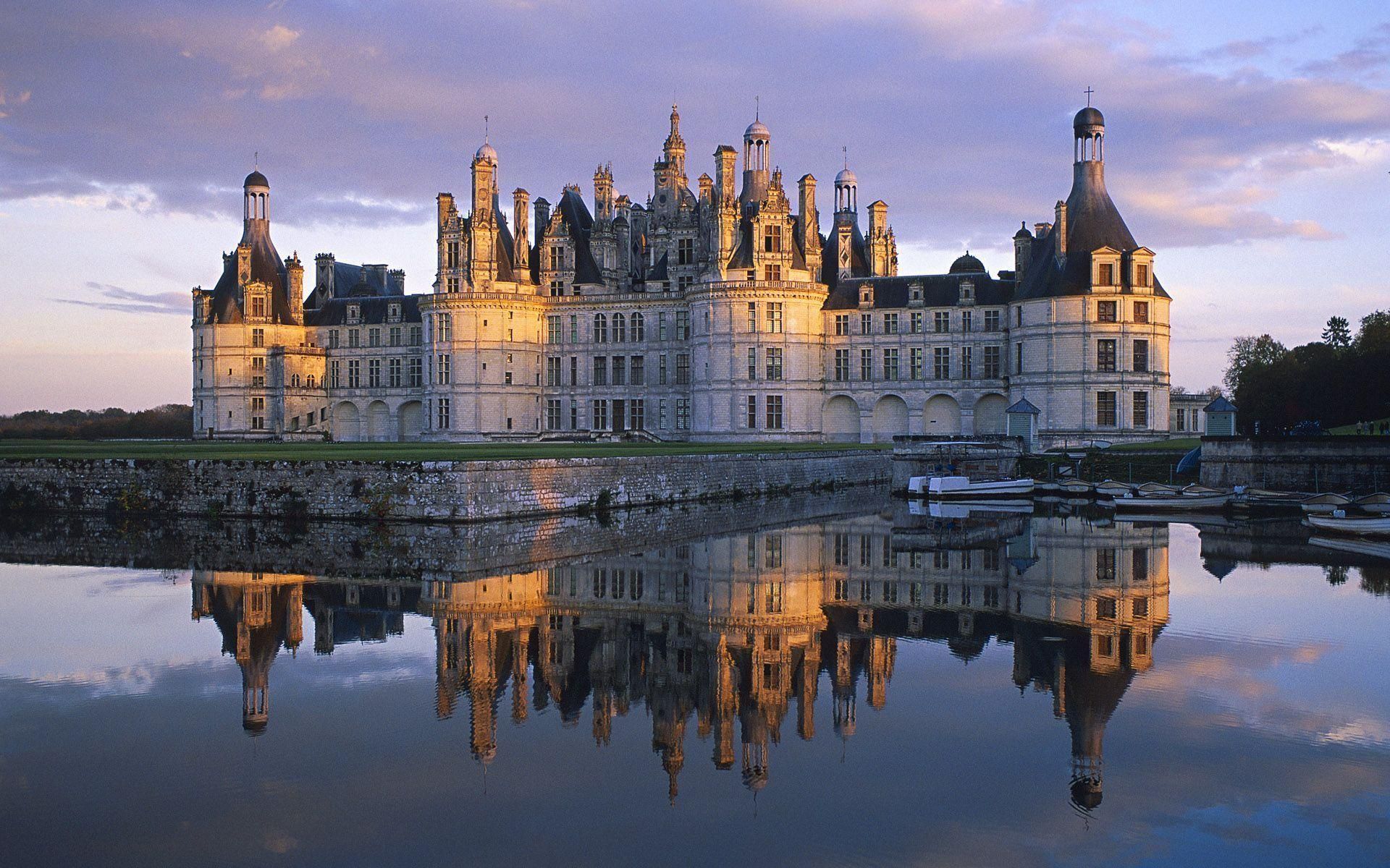 A large castle is reflected in the water - Castle