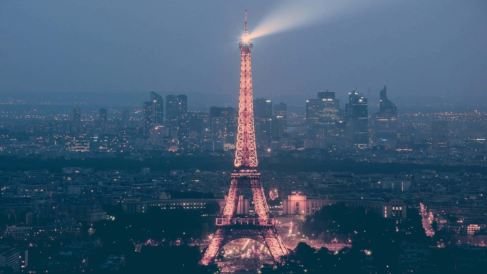 The eiffel tower is lit up at night - Paris