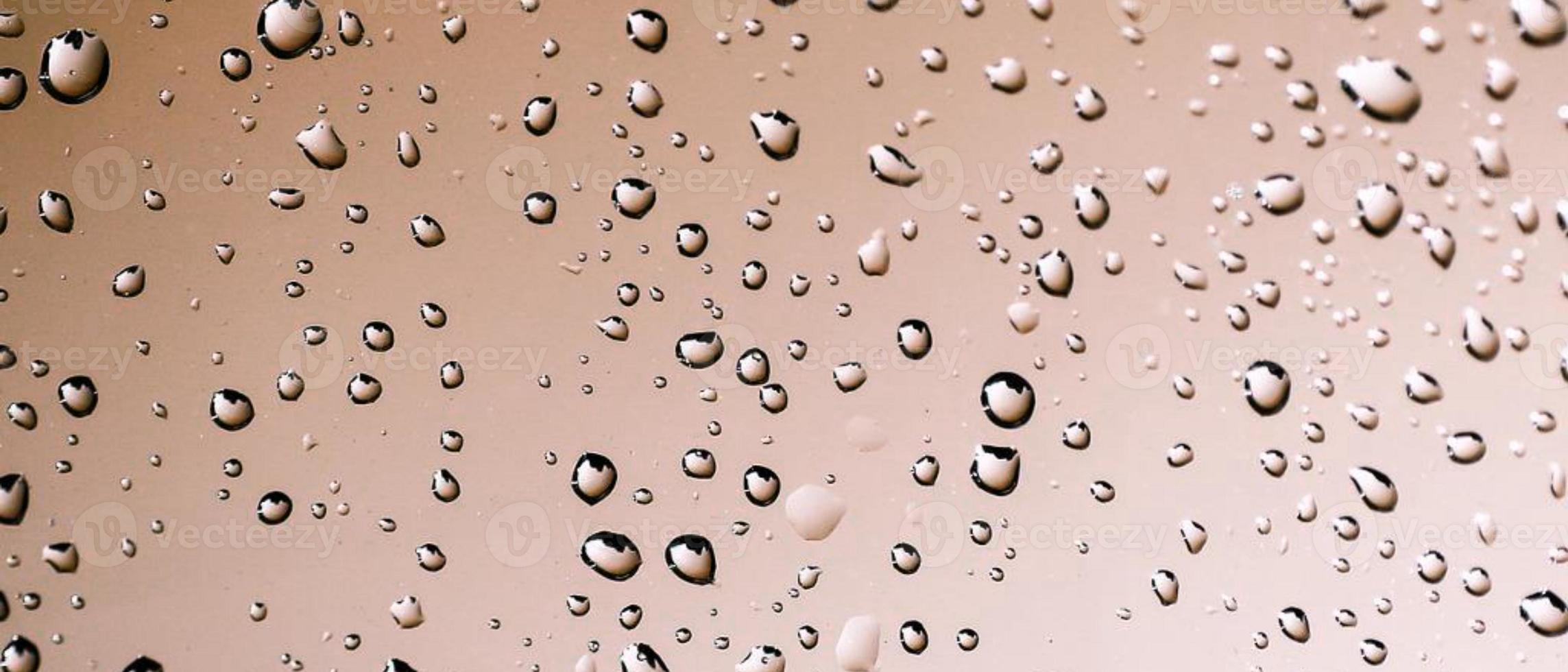 Water droplets on a glass surface photo - Champagne