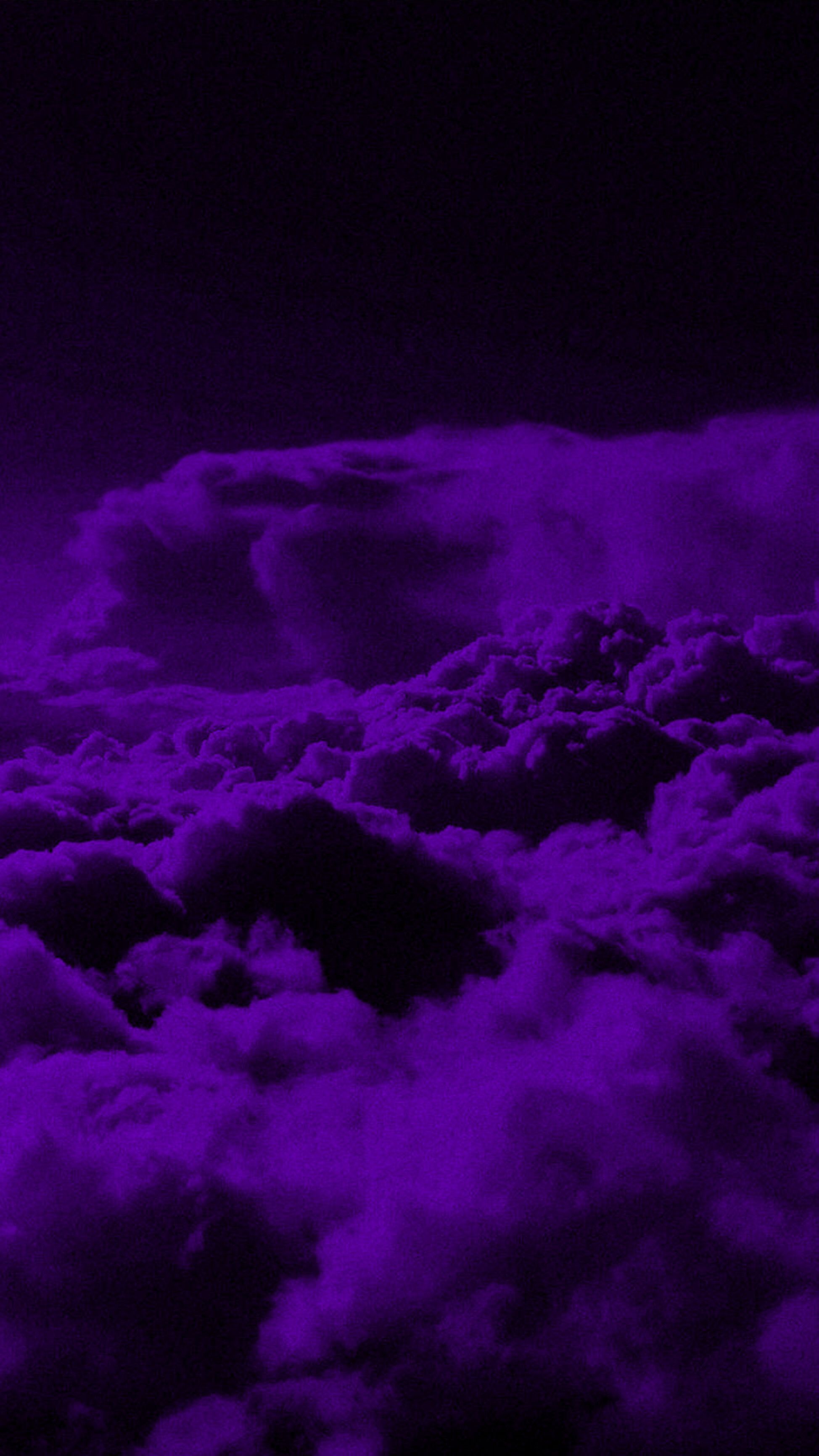 A purple sky with clouds and an airplane - Dark purple