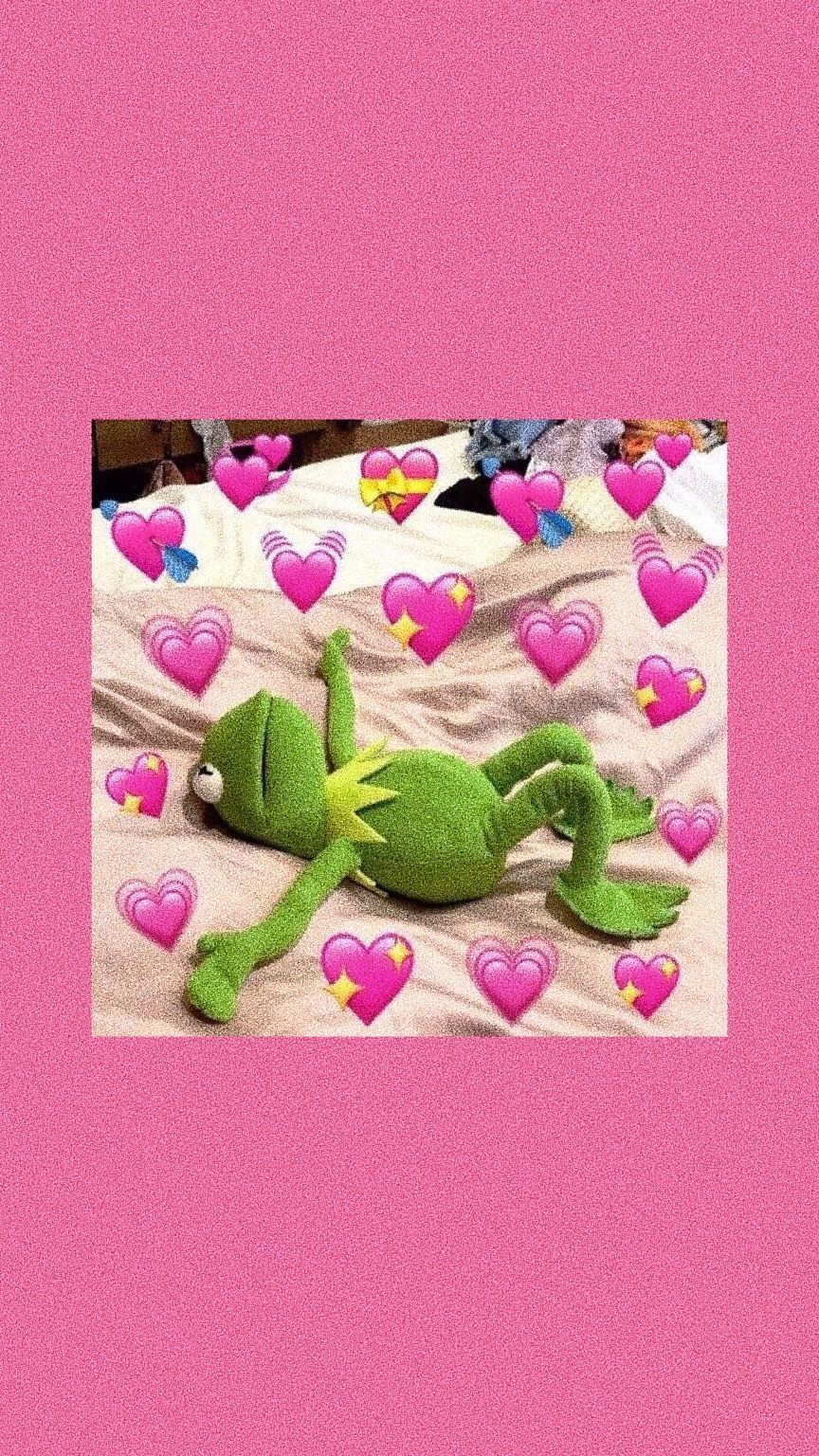 A green frog is laying on top of pink hearts - Kermit the Frog, frog