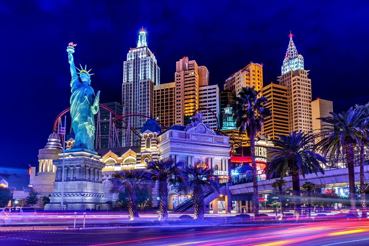 A city skyline with a statue of liberty in the foreground - Las Vegas