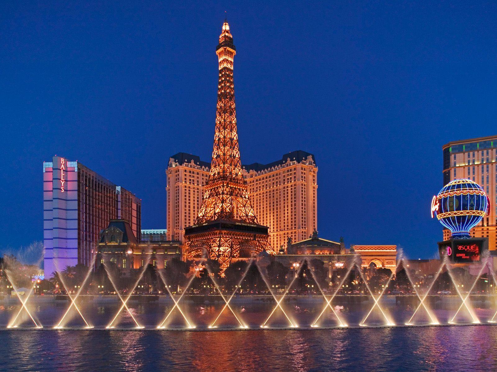 The Bellagio Fountains with the Eiffel Tower at night - Las Vegas