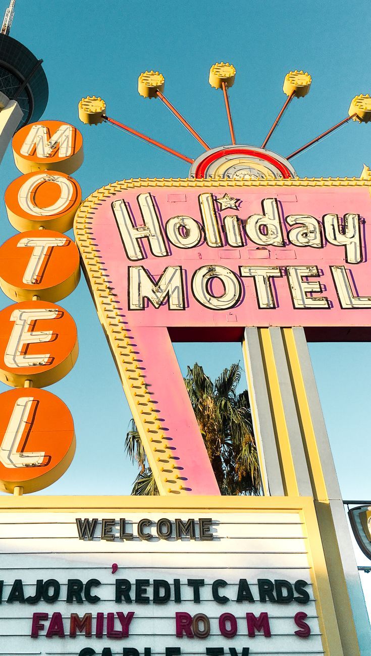 A motel sign in Las Vegas with a blue sky in the background. - Las Vegas