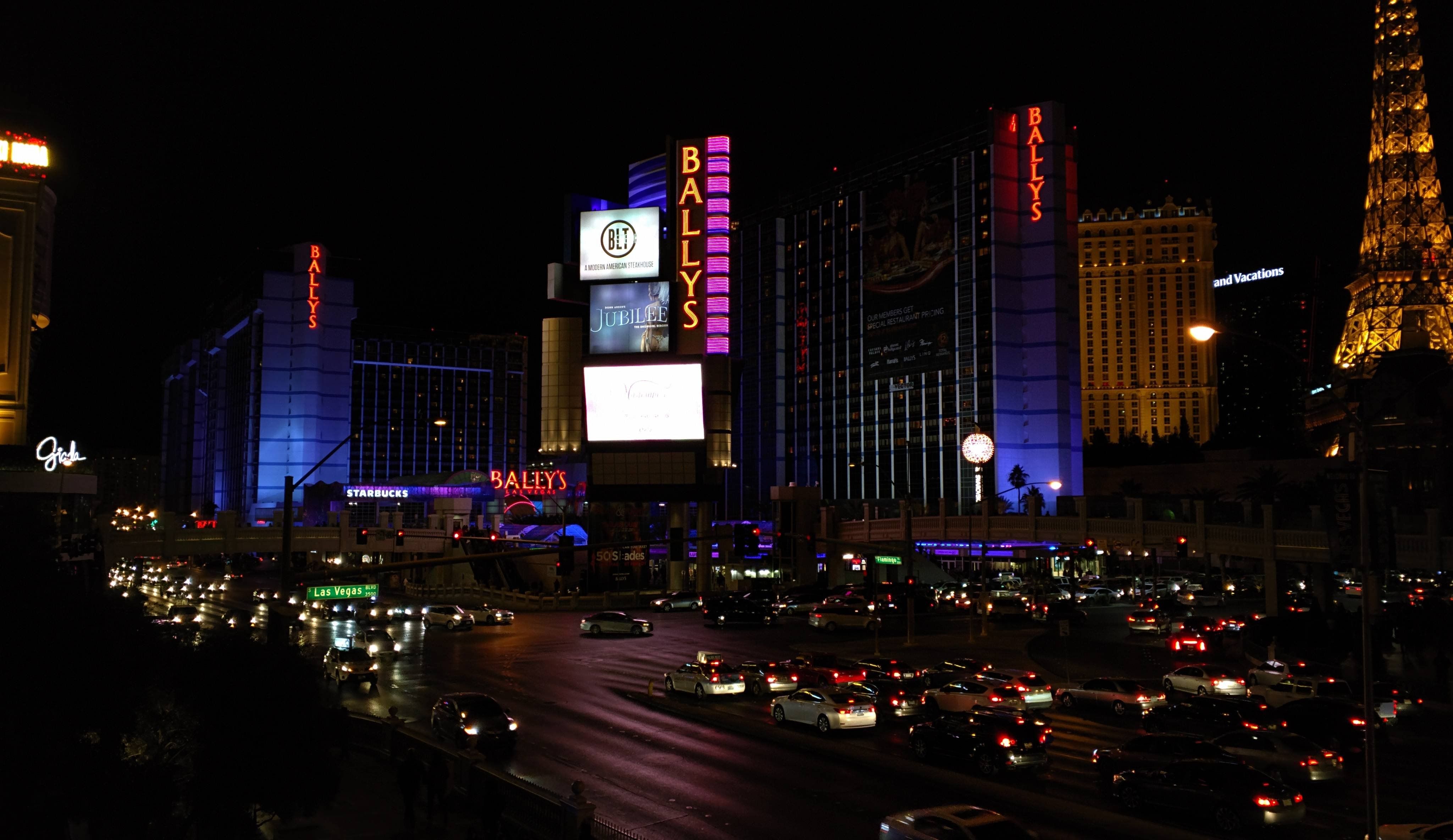 A city street with many cars and neon lights - Las Vegas