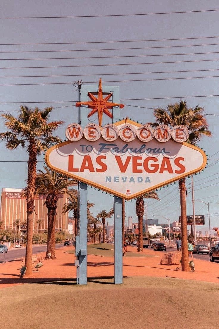 The famous Las Vegas sign with palm trees in the background - Las Vegas