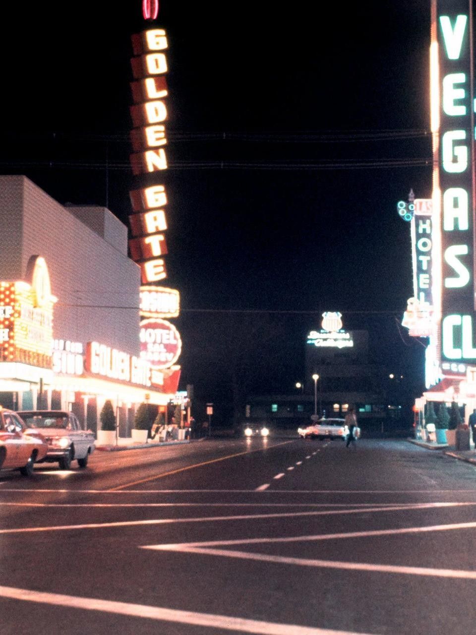 The Golden Gate hotel and casino is seen lit up at night in this undated photo. - Las Vegas