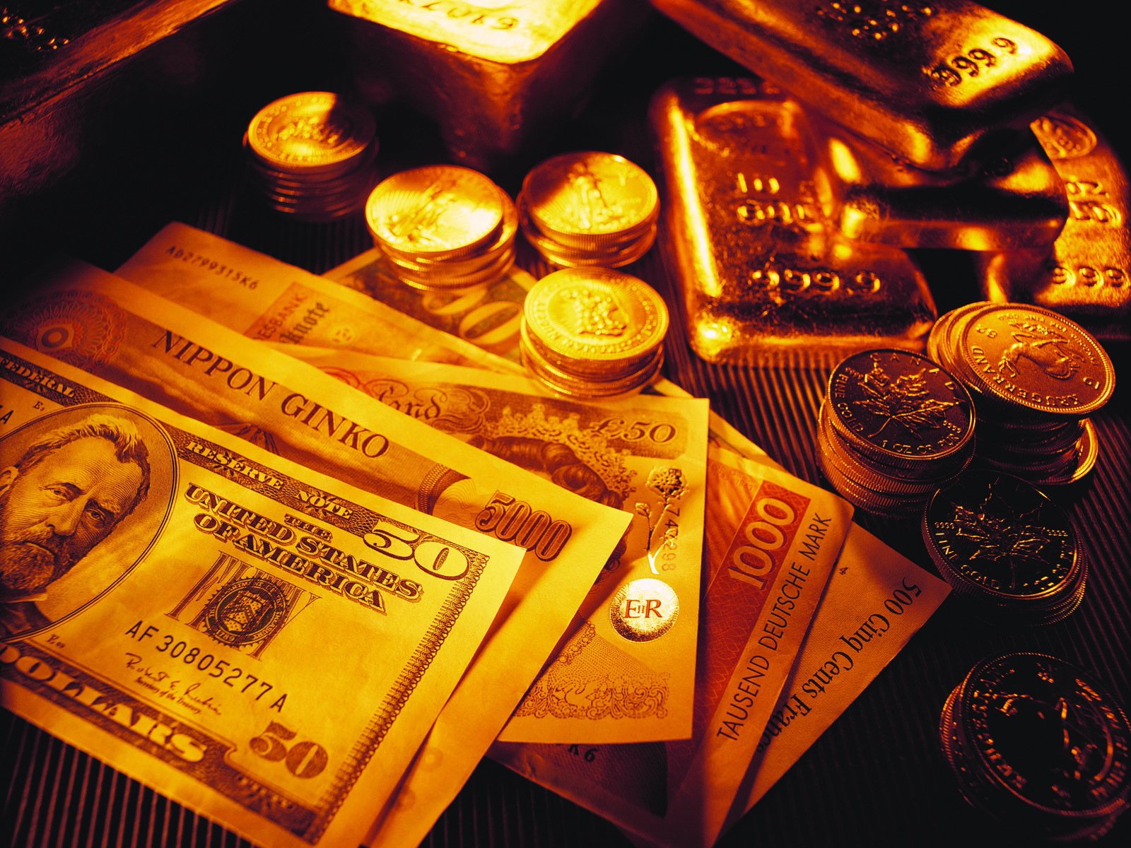 Gold bars and coins with a pile of US currency - Money