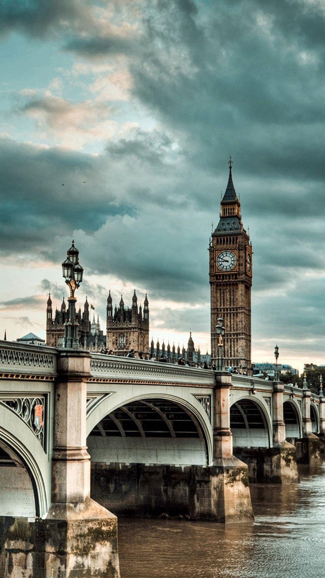 A bridge with buildings on it and water underneath - London