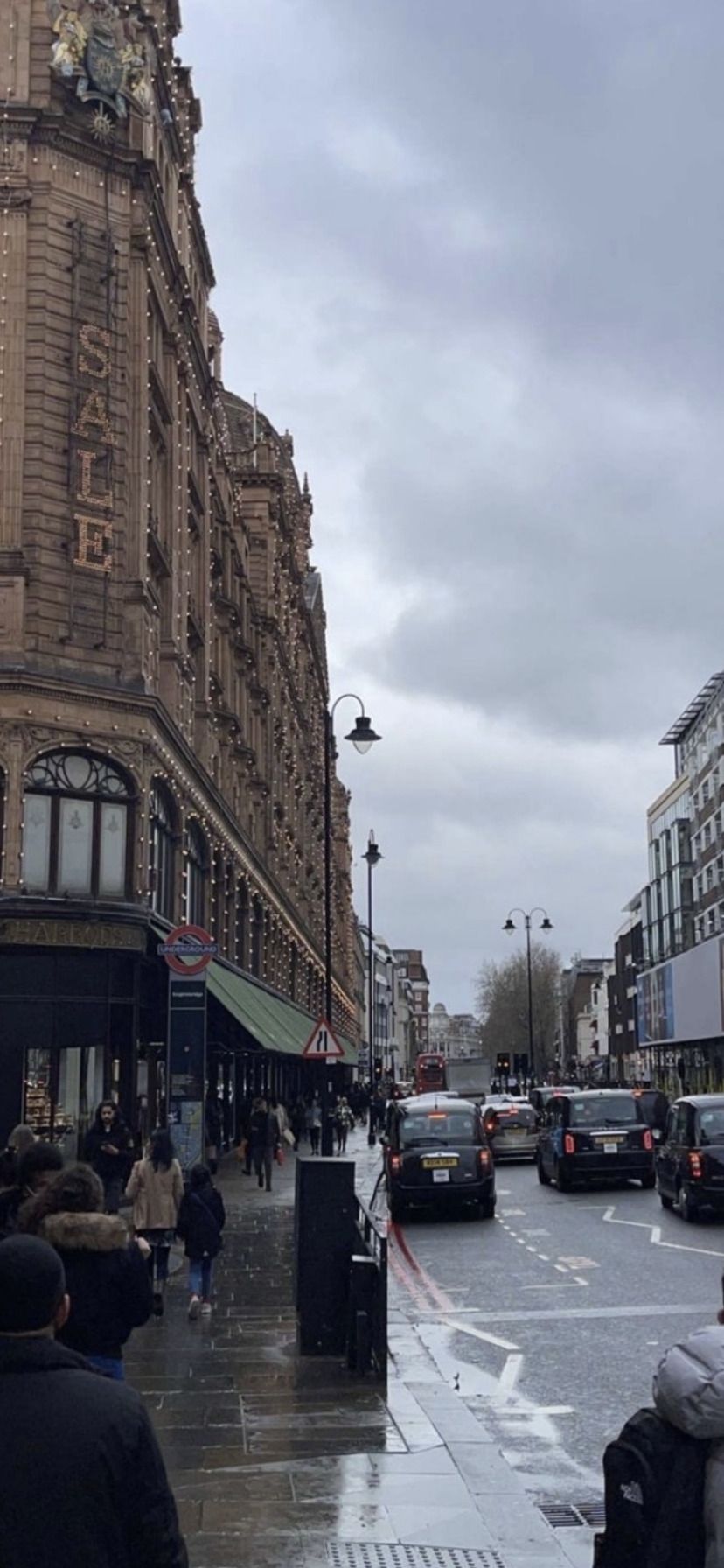 A group of people walking down the street - London