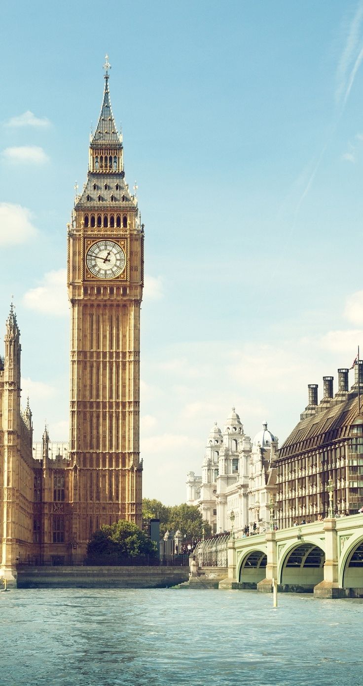 A large clock tower with a clock on each of it's sides. - London