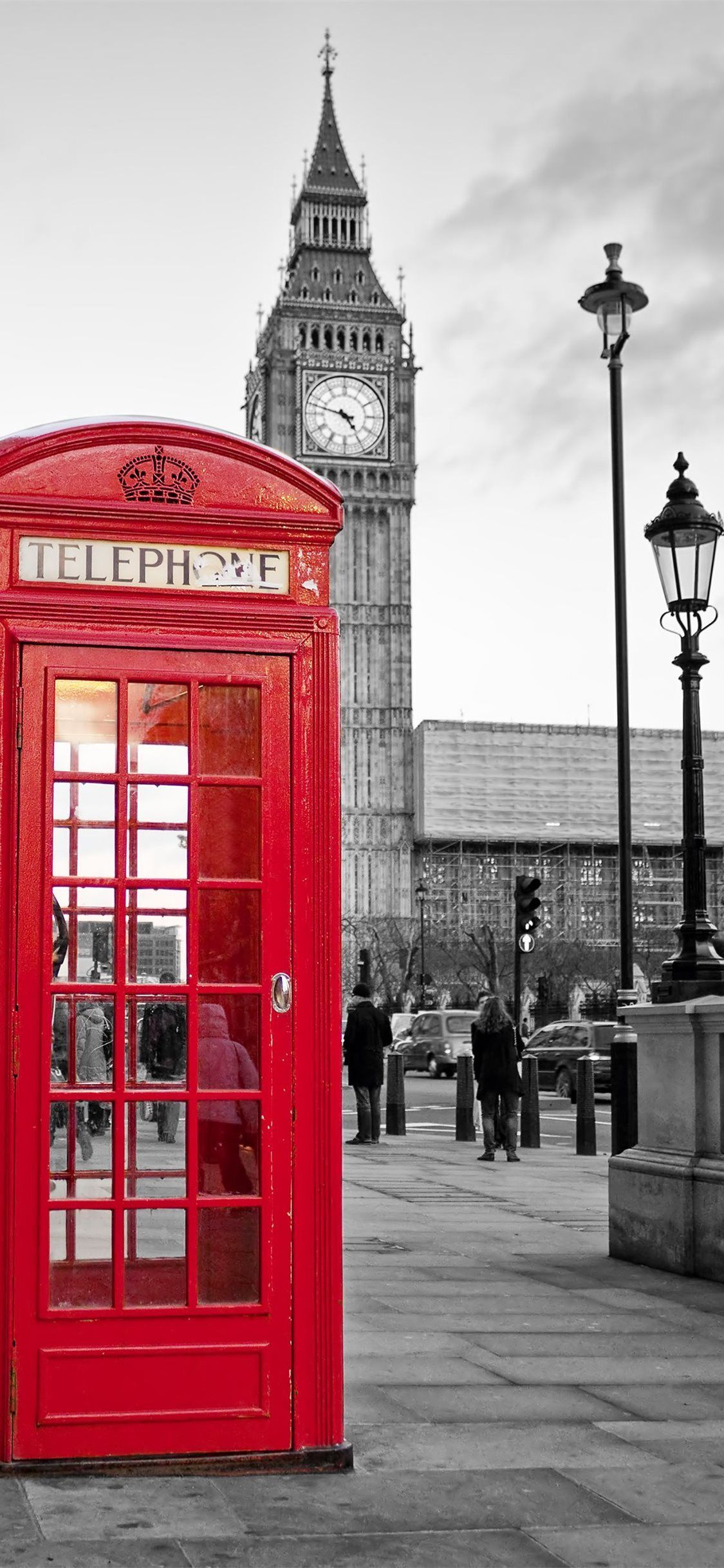 A red phone booth in front of big ben - London