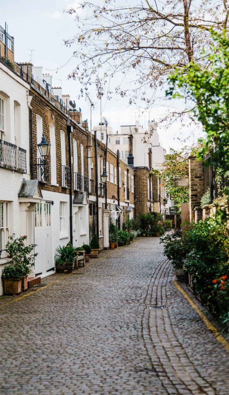 A cobblestone street with buildings on either side - London