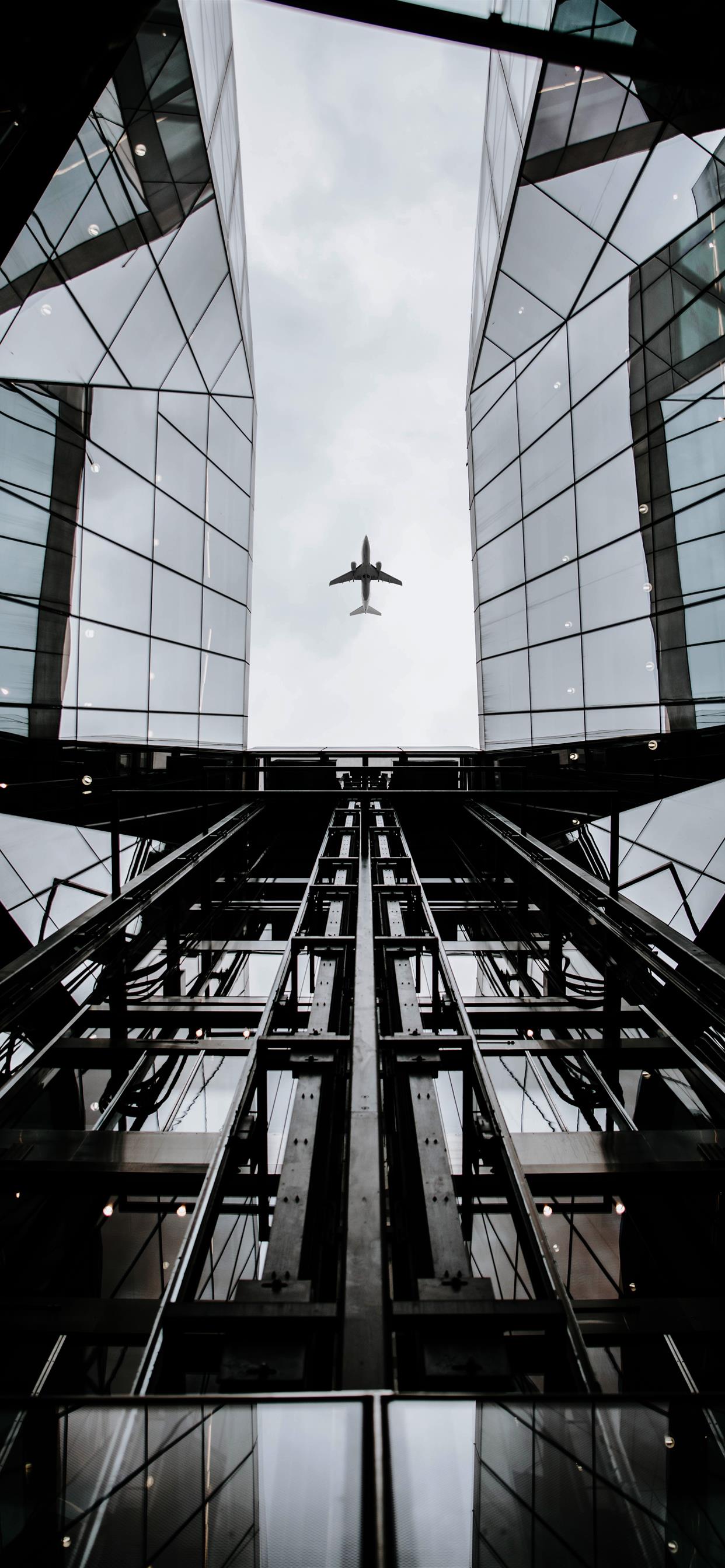 A plane flying over an office building - London