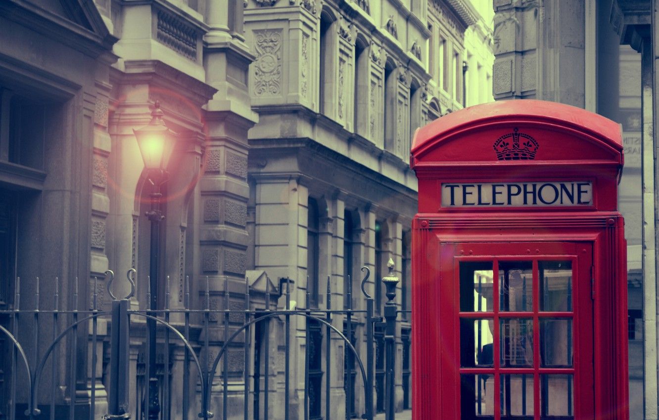 A red telephone booth is on the street - London