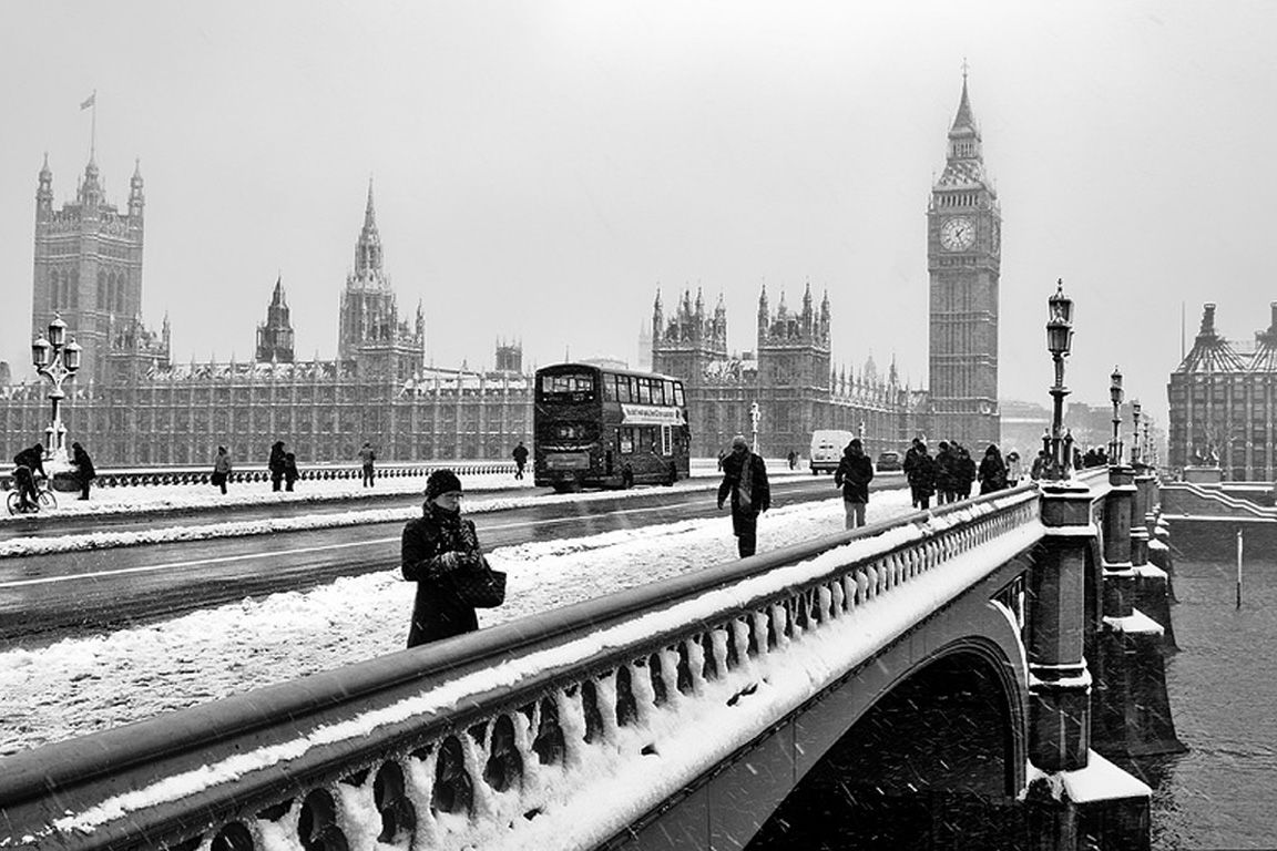 A black and white photo of a snowy London street with Big Ben in the background. - London