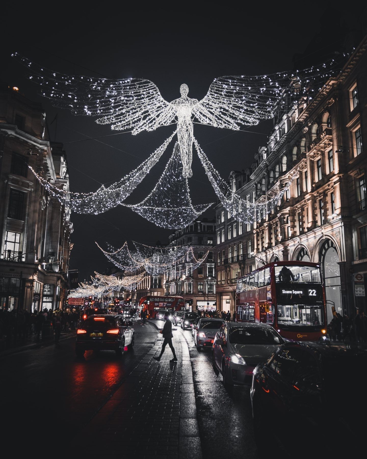 A person walking down the street at night - London