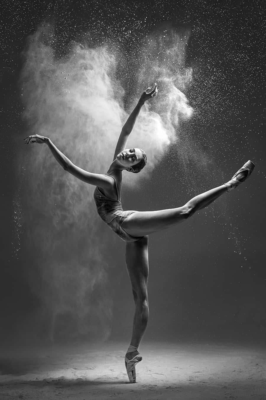 A black and white photograph of ballerina dancing in the air - Ballet