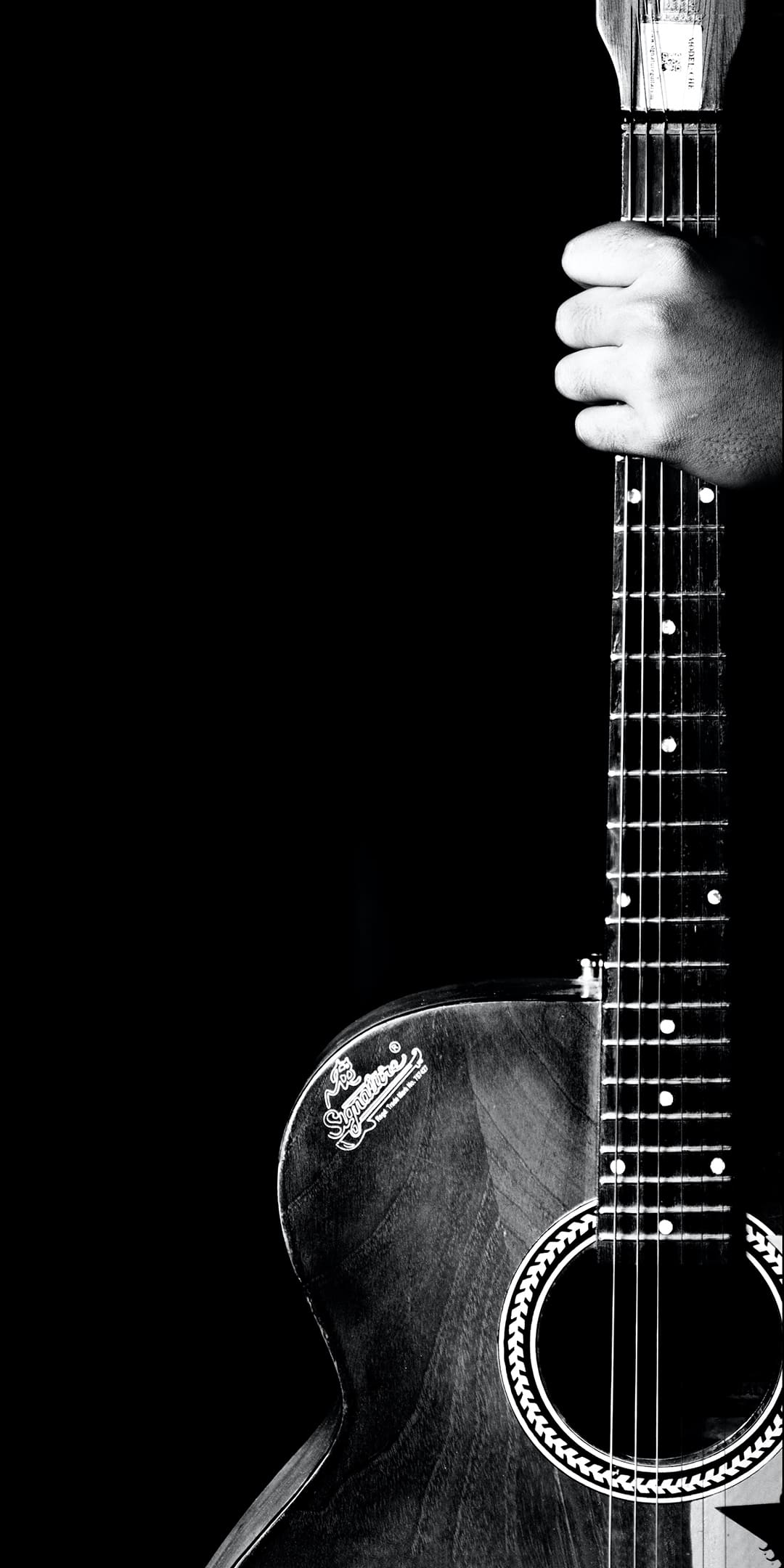 A black and white photo of an acoustic guitar - Guitar