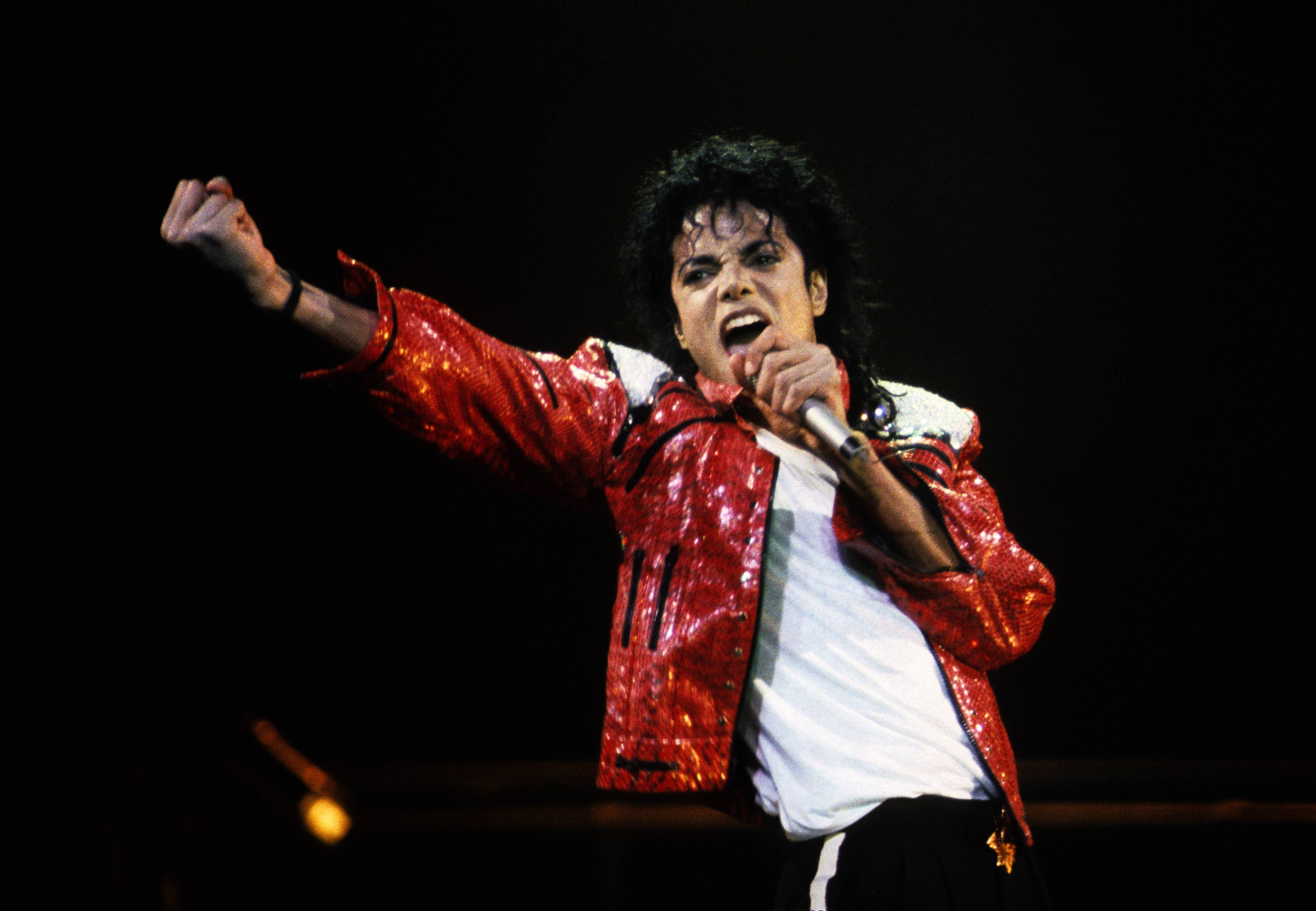 Michael Jackson performing on stage in a red jacket - Michael Jackson