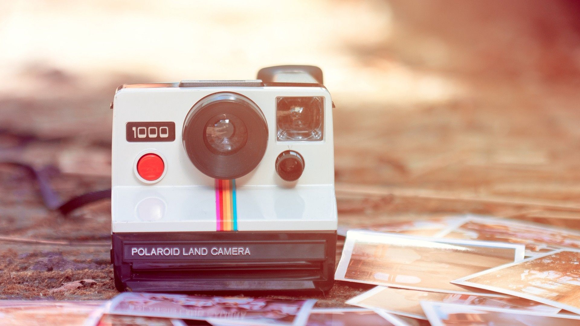 A polaroid camera is sitting on the ground - Polaroid