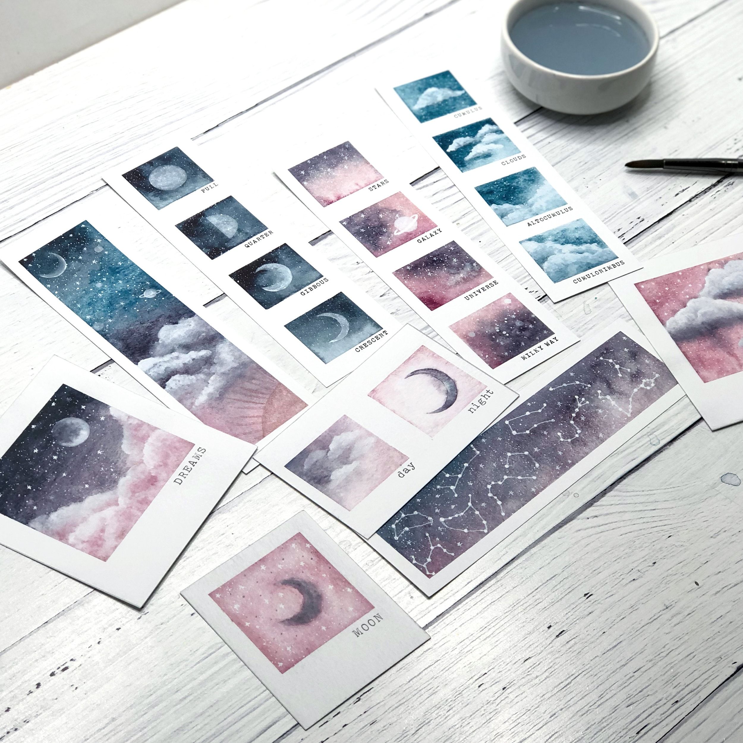 A table with pictures of the moon and stars - Polaroid