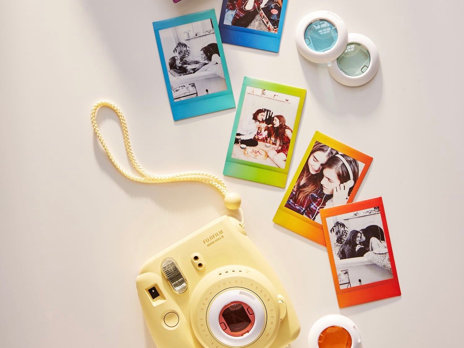 A yellow camera with colorful pictures on it - Polaroid