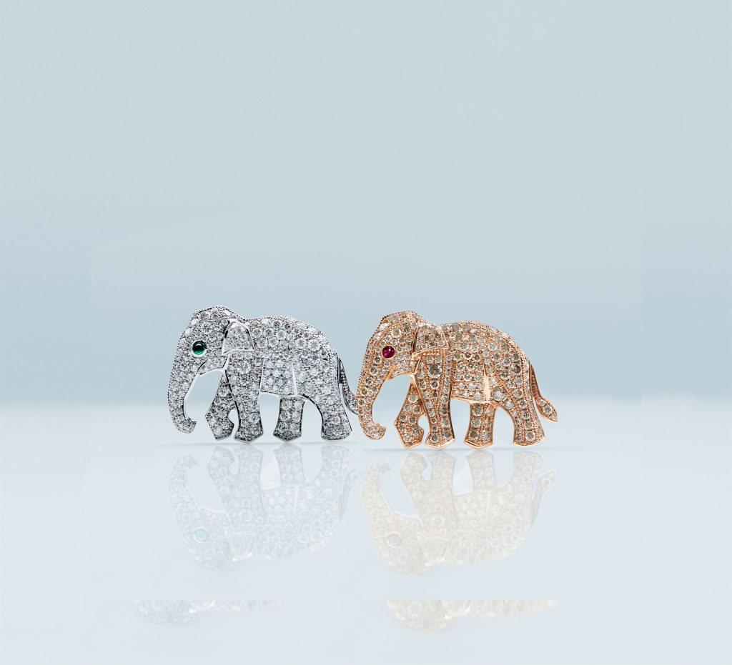 Two diamond elephant brooches, one in white gold and the other in rose gold, with a red diamond eye. - Elephant