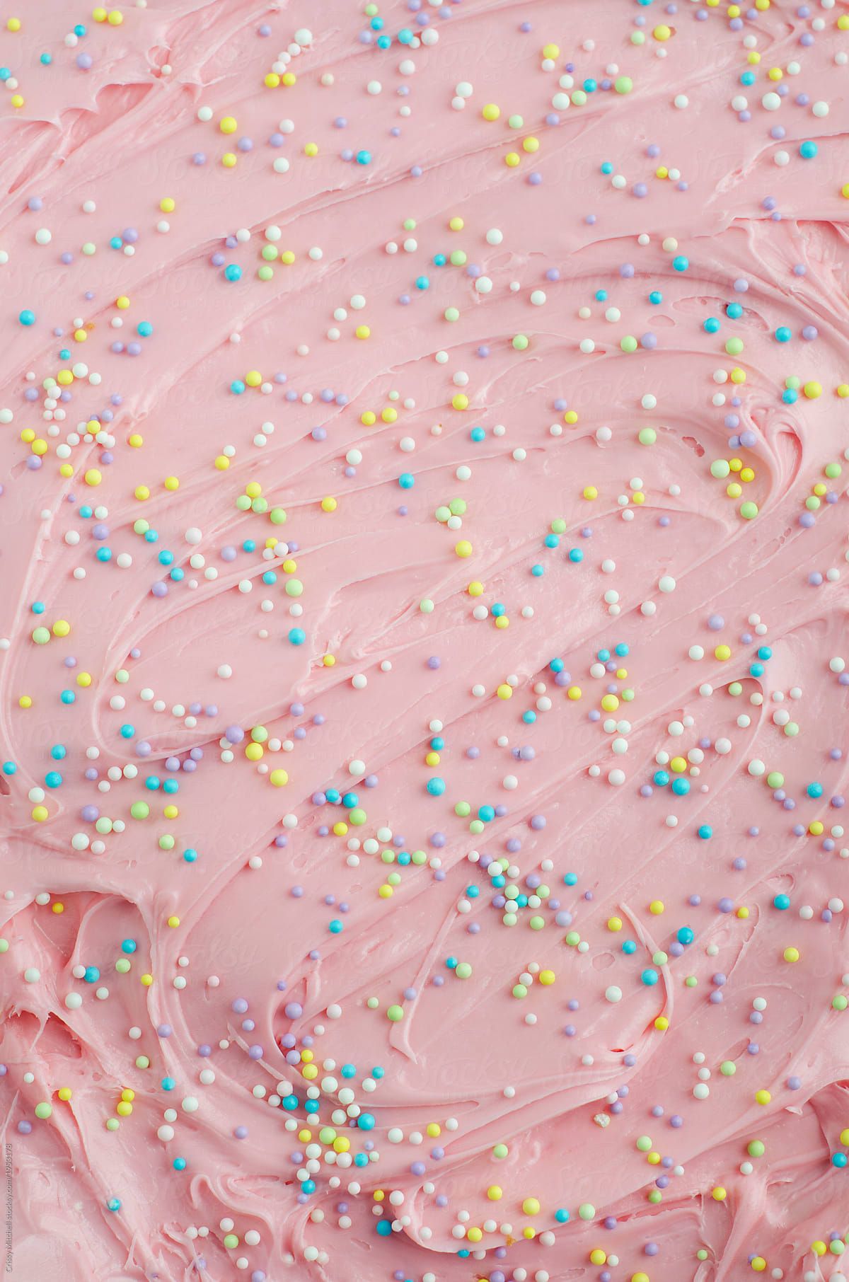 Close up of pink frosting with sprinkles on a cake - Bakery