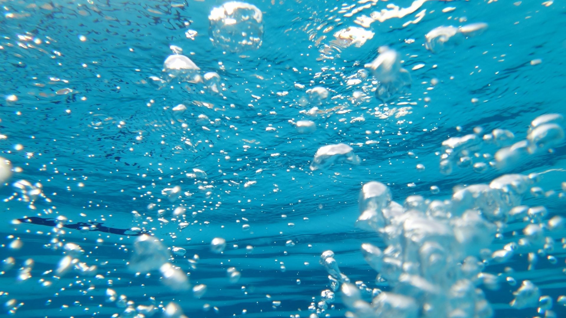 Underwater view of bubbles rising to the surface of a pool - Bubbles