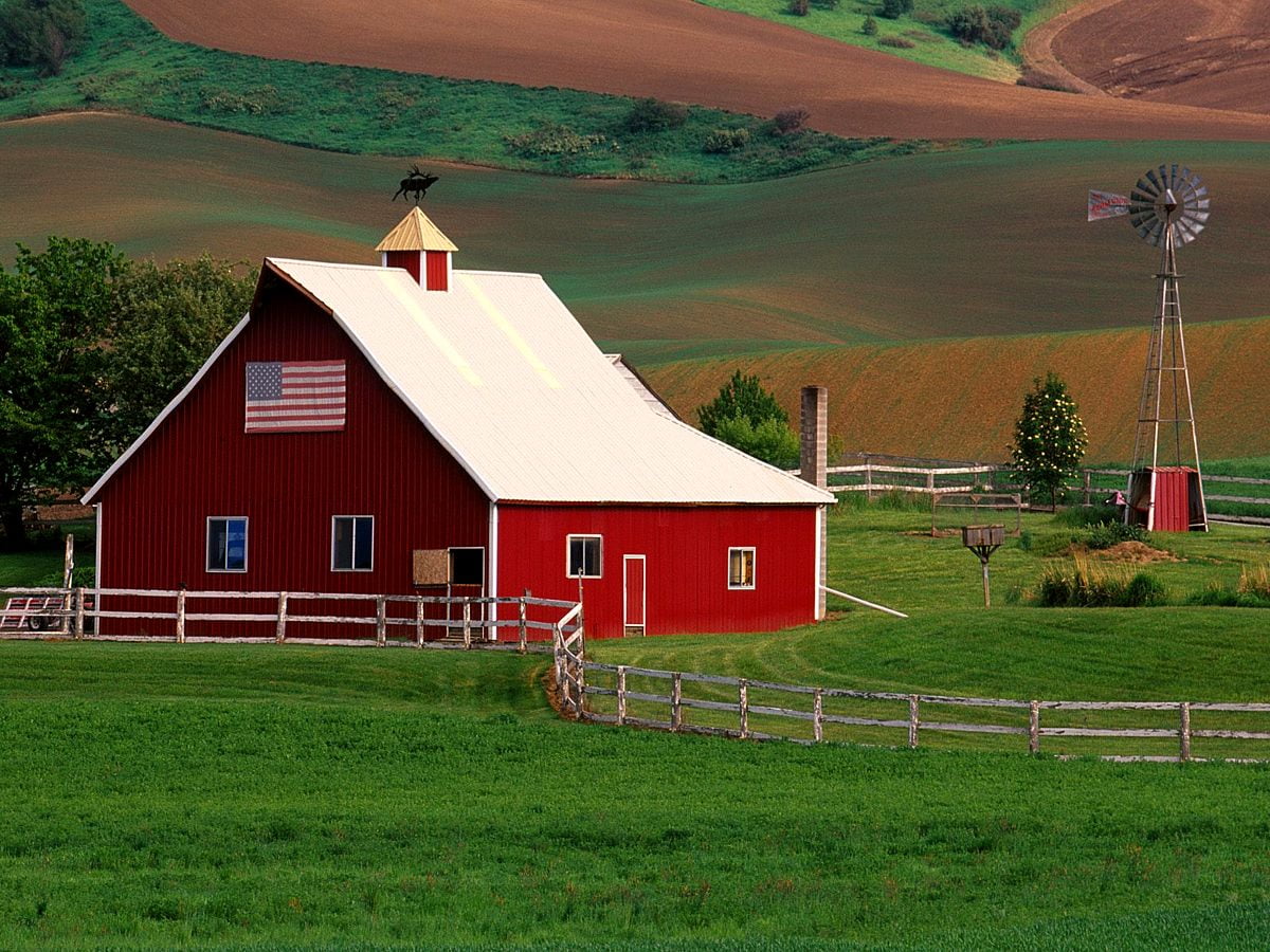 A red barn with an american flag on top - Farm