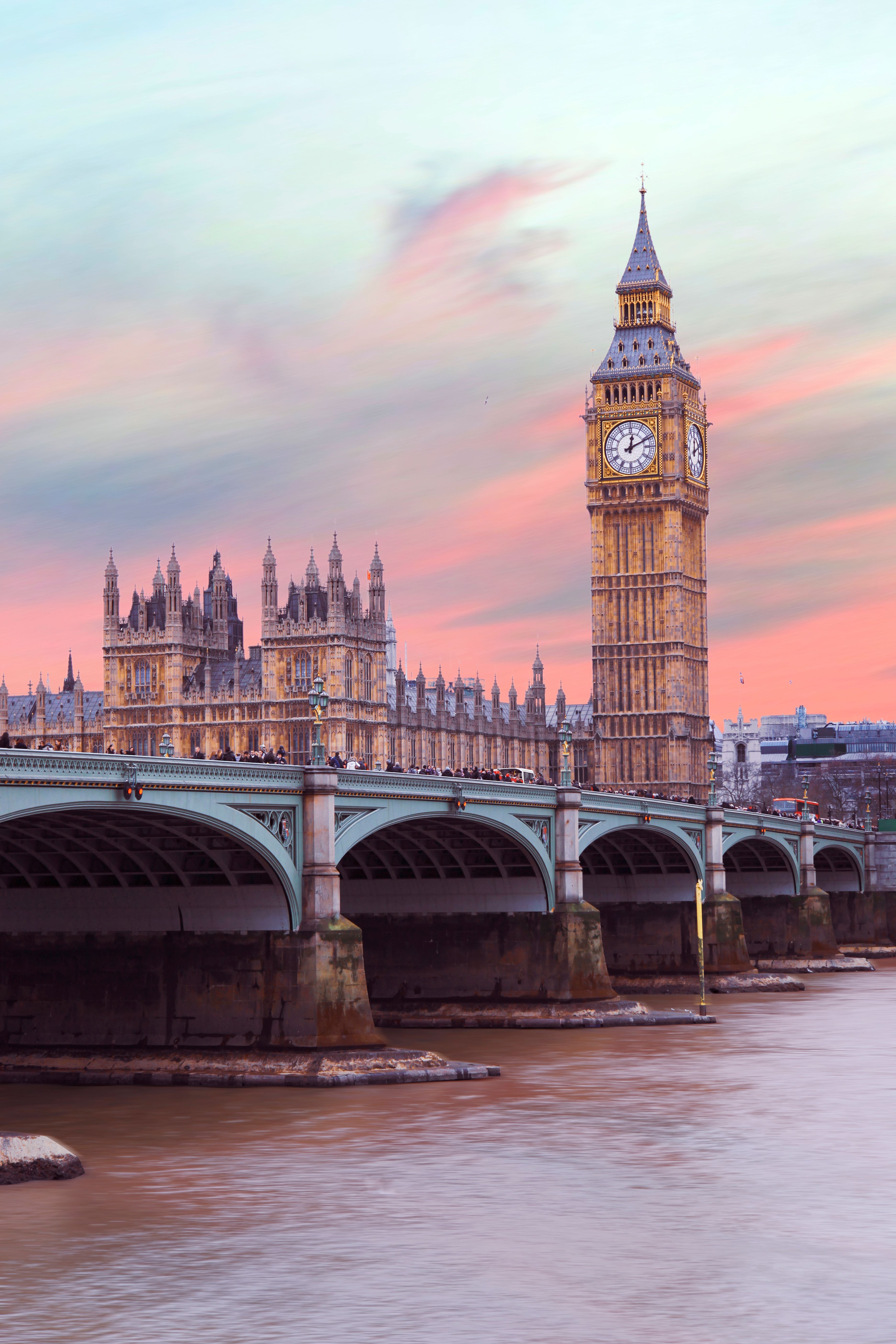 A bridge with buildings on it and water - London