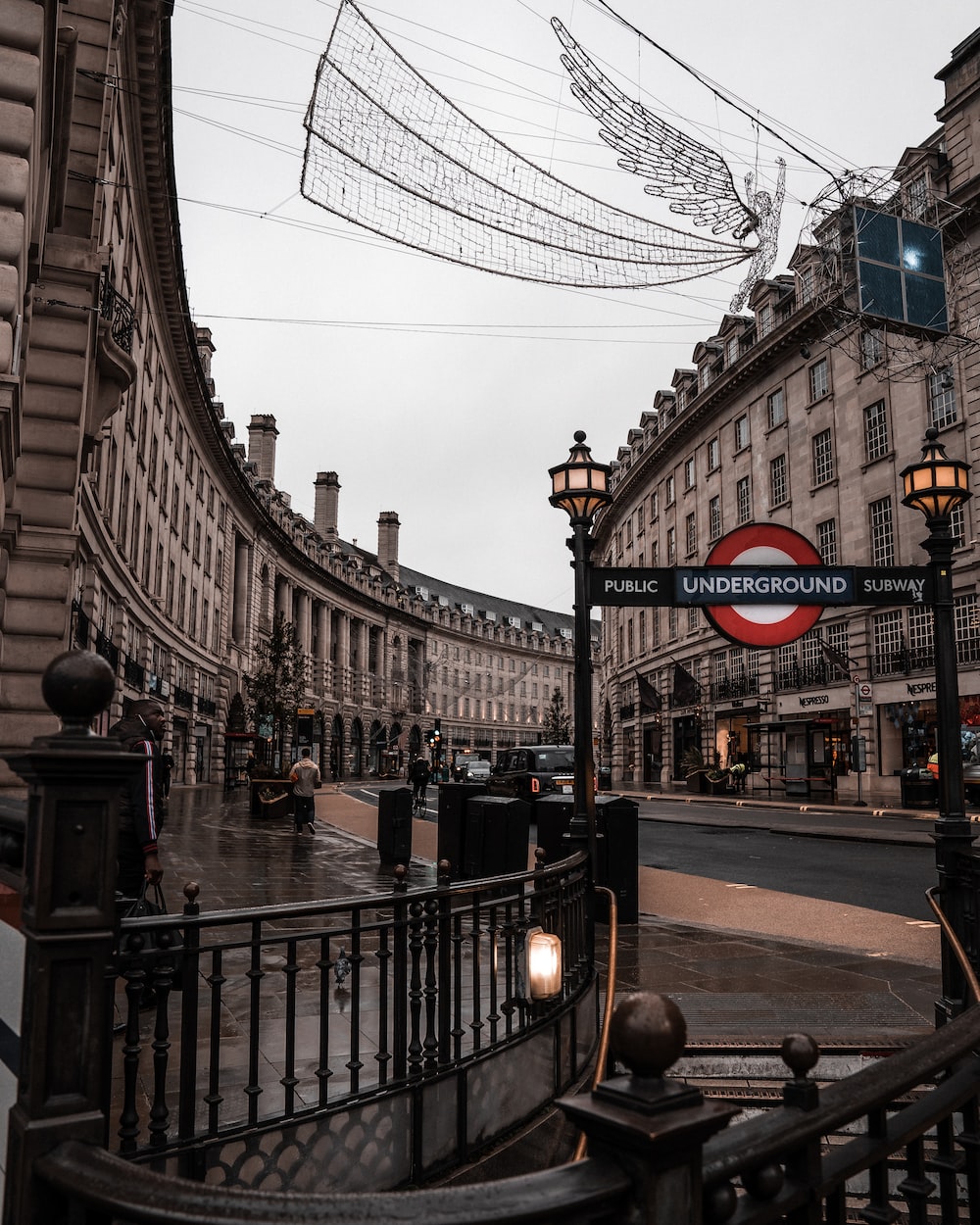 Black and white photo of people walking on the street - London