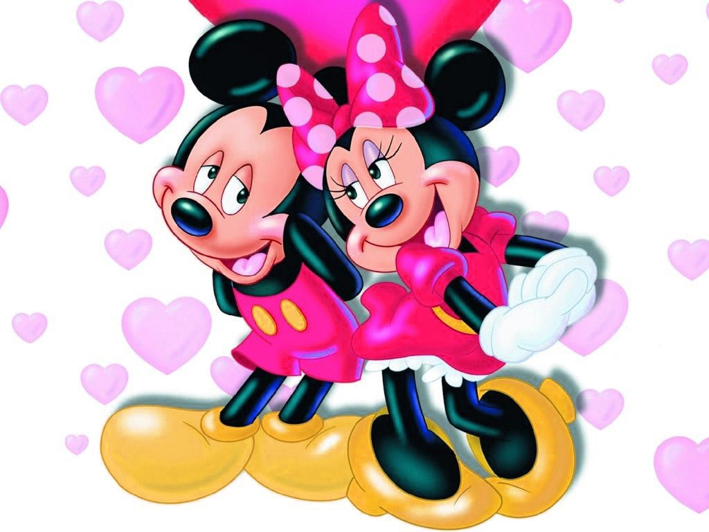 The minnie and mickey mouse are holding hearts - Minnie Mouse