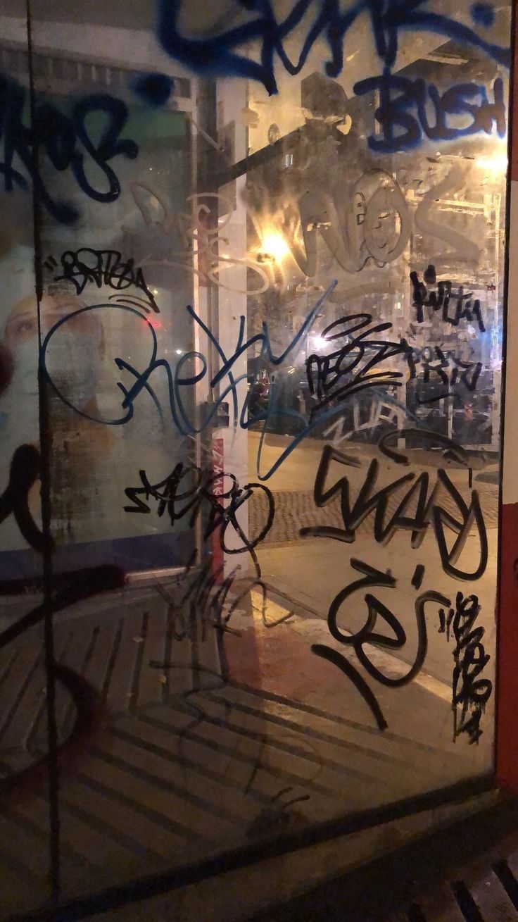 A mirror with graffiti on it in the middle of an alley - Graffiti