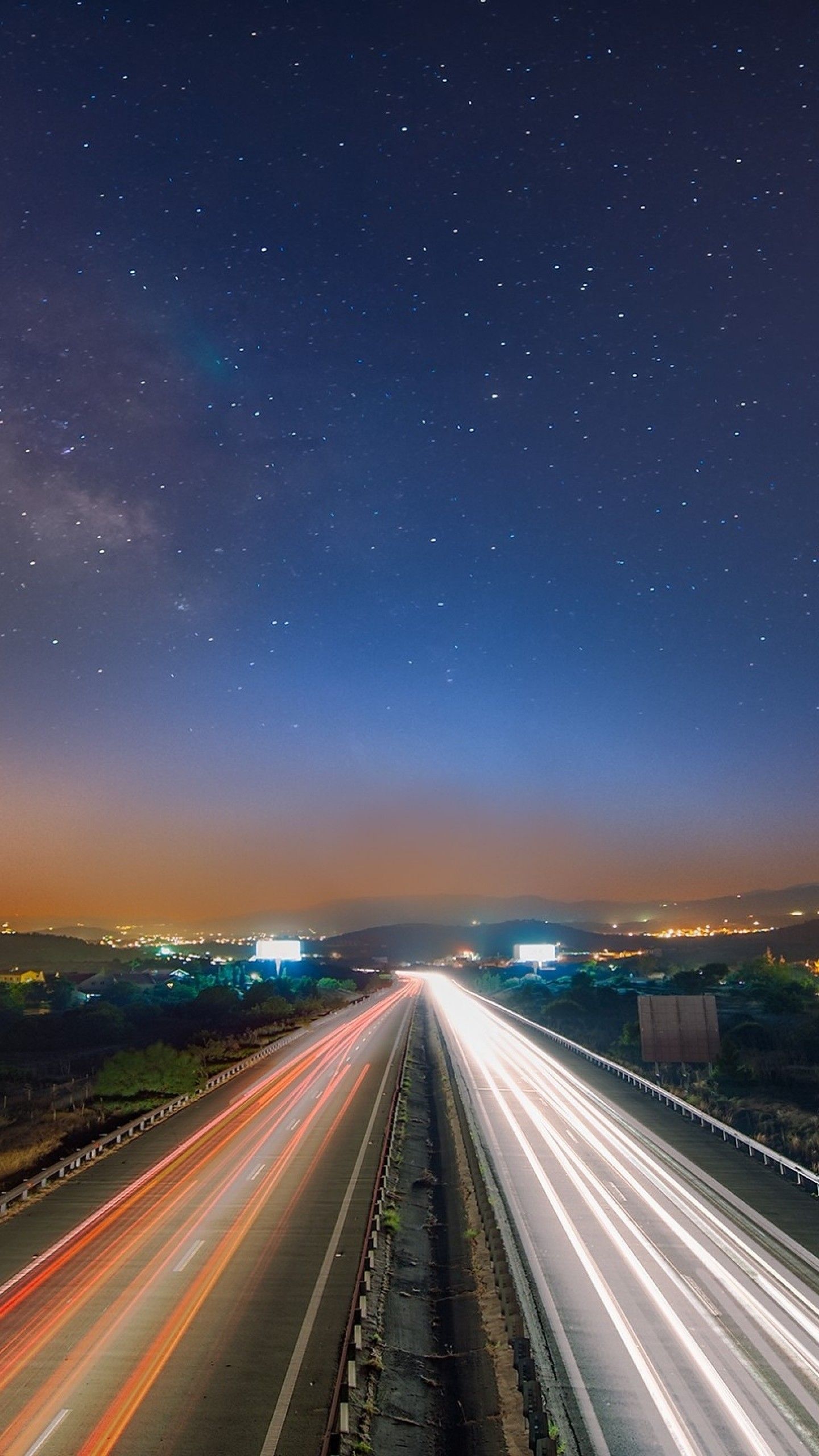 A highway with cars driving on it at night - Road