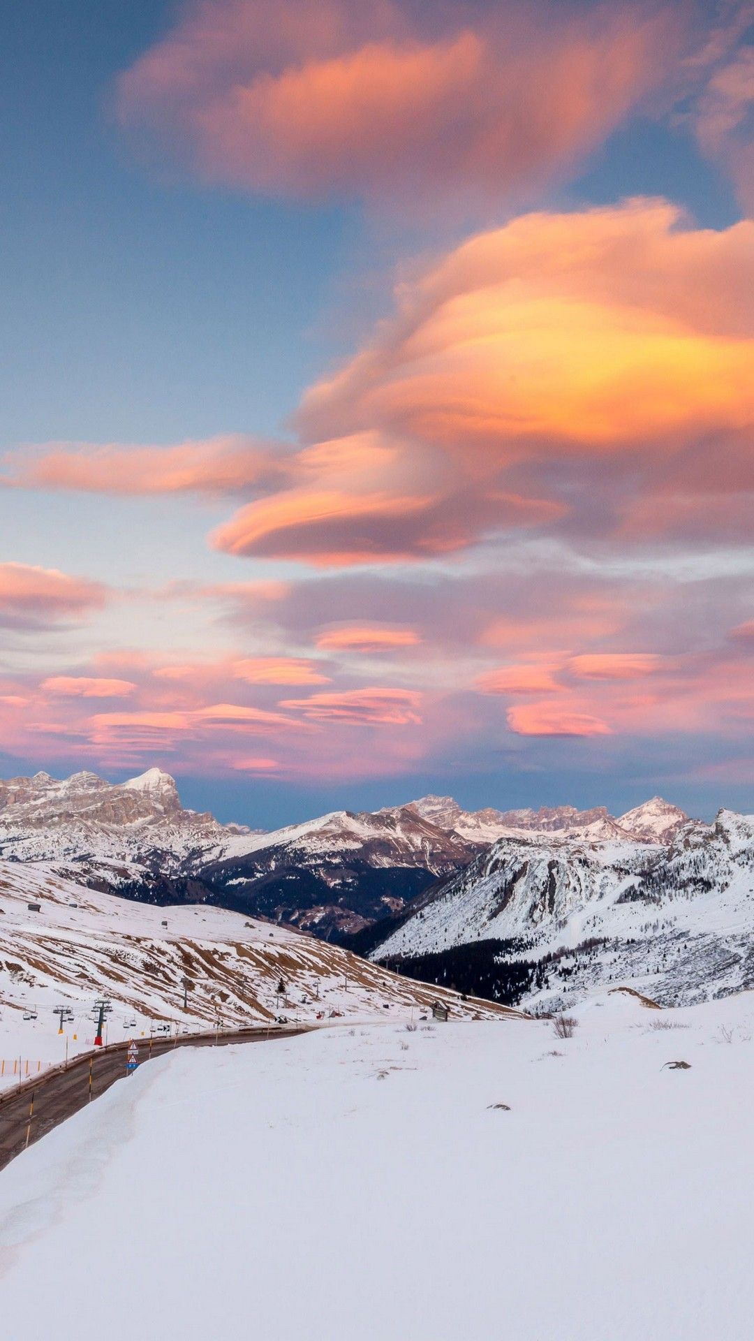 A beautiful shot of a snowy mountain range with a pink and blue sunset sky - Winter, snow, ice