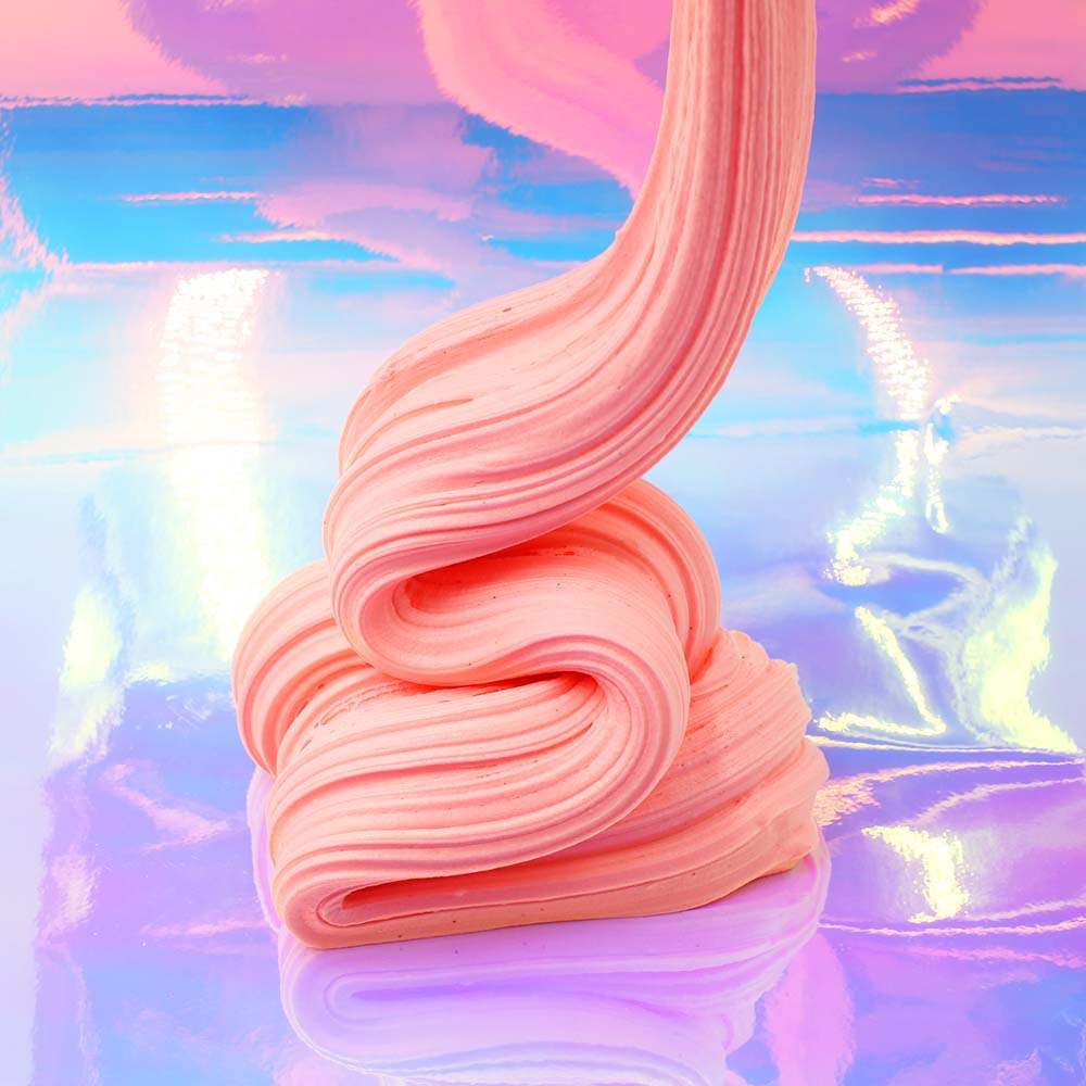 A swirled pile of pink slime sits on a reflective surface. - Slime