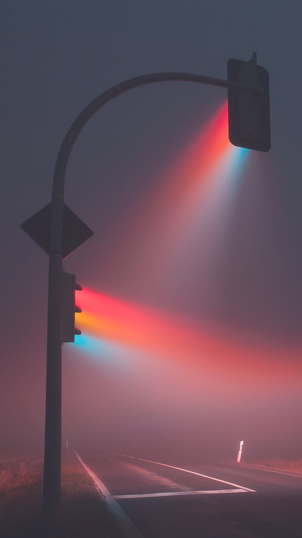 A traffic light with a rainbow of light coming from it. - VHS, road, fog, magic, rainbows, TikTok
