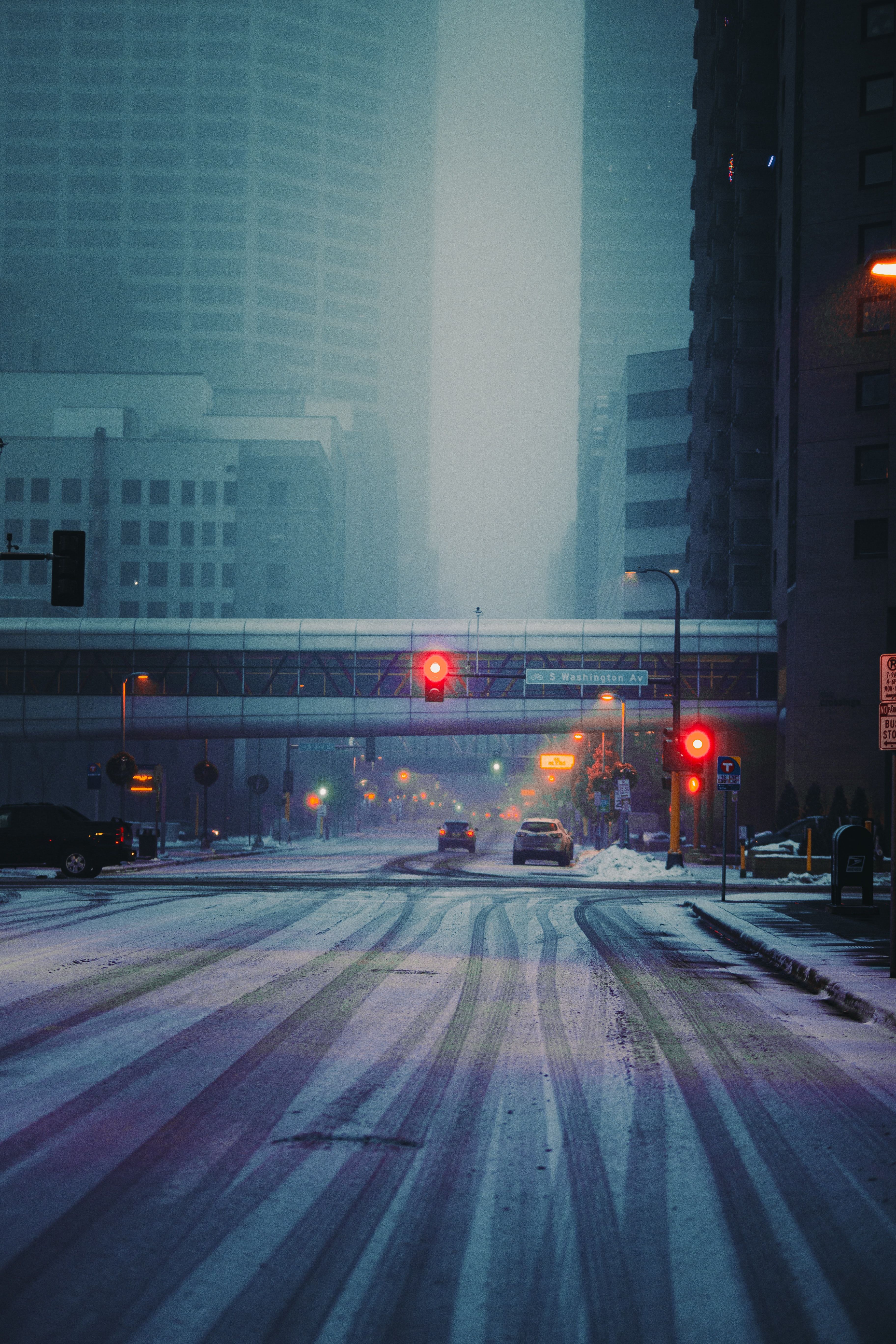 A street with snow and traffic lights - Road