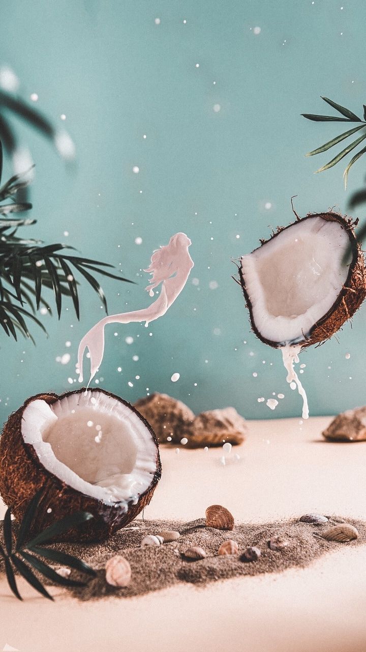 A mermaid made out of coconut milk spills out of a coconut - Coconut