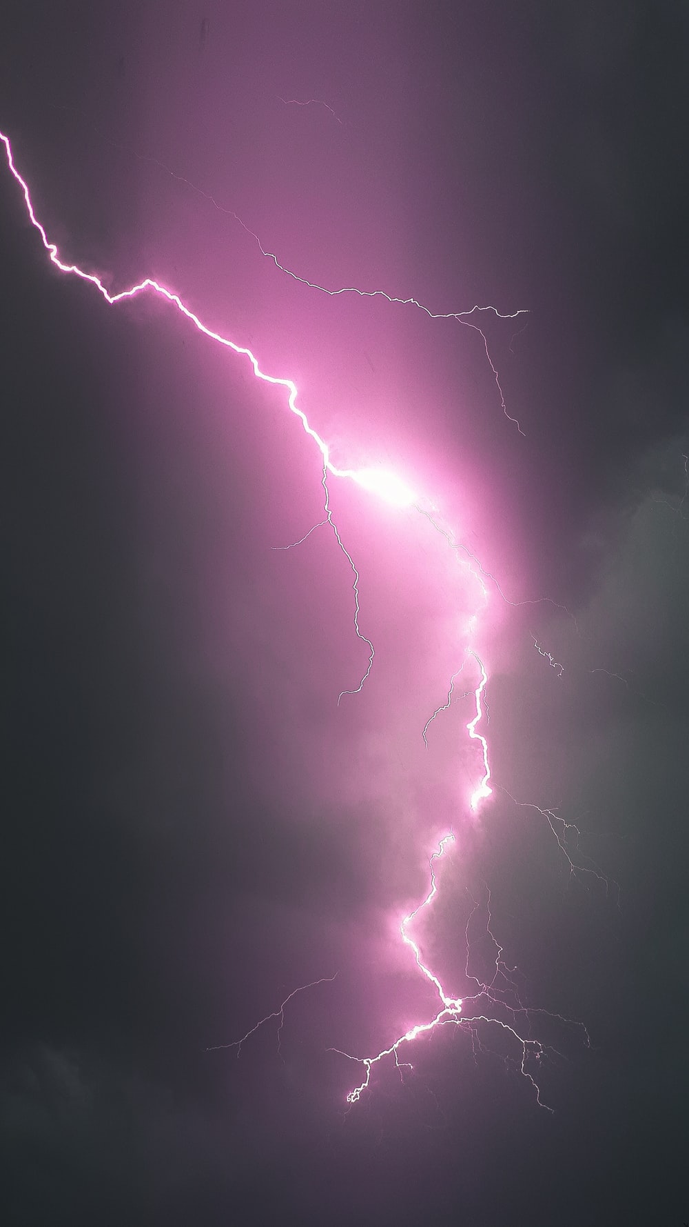 A purple lightning bolt in a dark purple sky. - Lightning