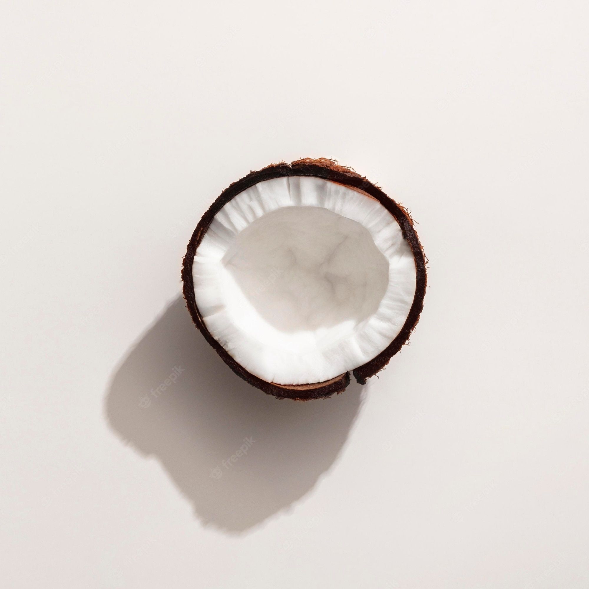 Half of a coconut on a white background - Coconut