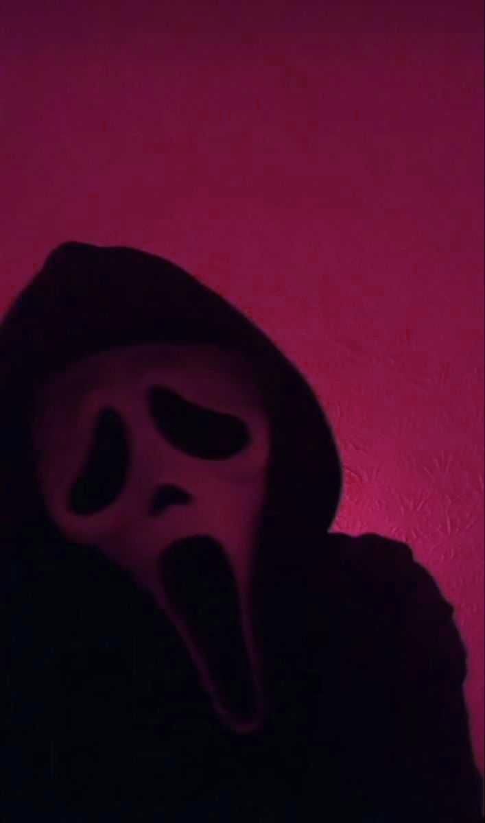 A person in the dark with their face covered - Ghostface