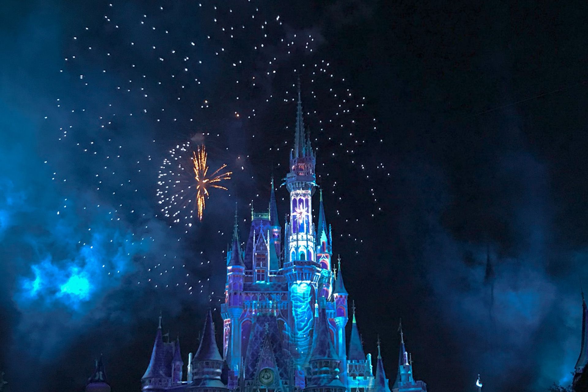 A castle with fireworks in the sky - Disneyland