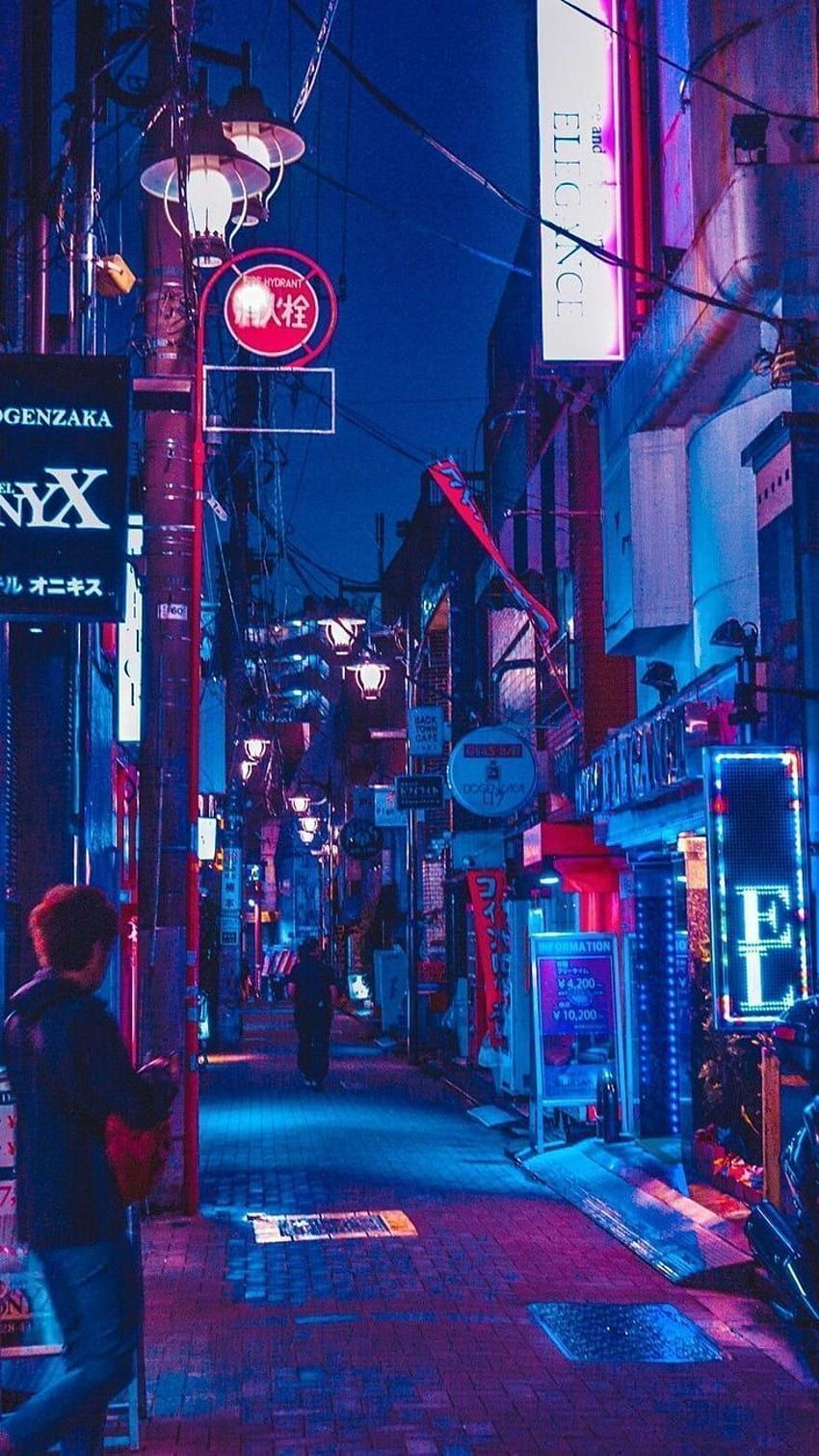 A person walking down an alley at night - Seoul