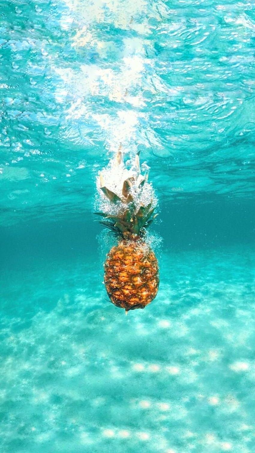 A pineapple is floating in the water - Pineapple