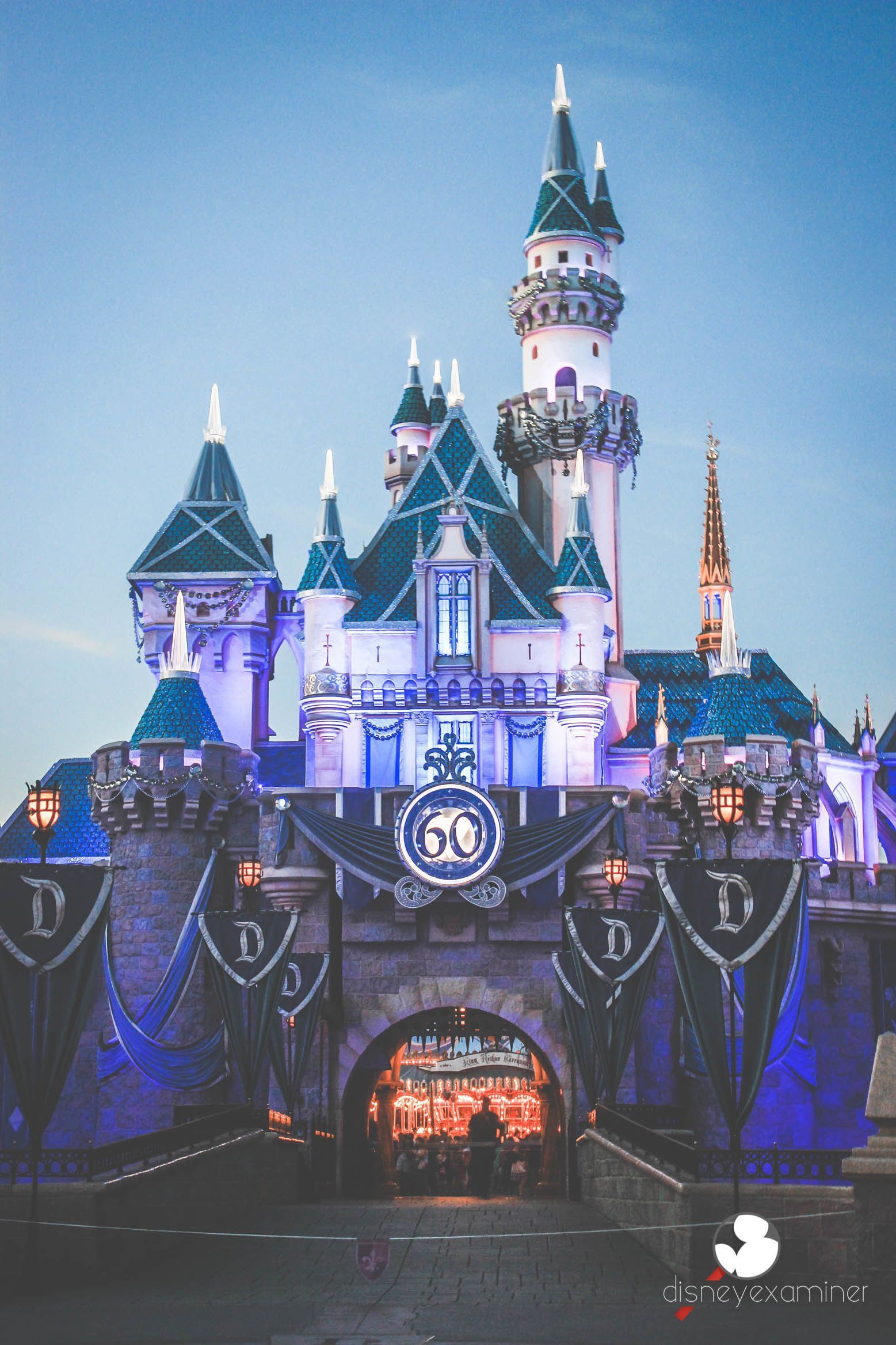 Disneyland 60th anniversary castle with a banner that says 