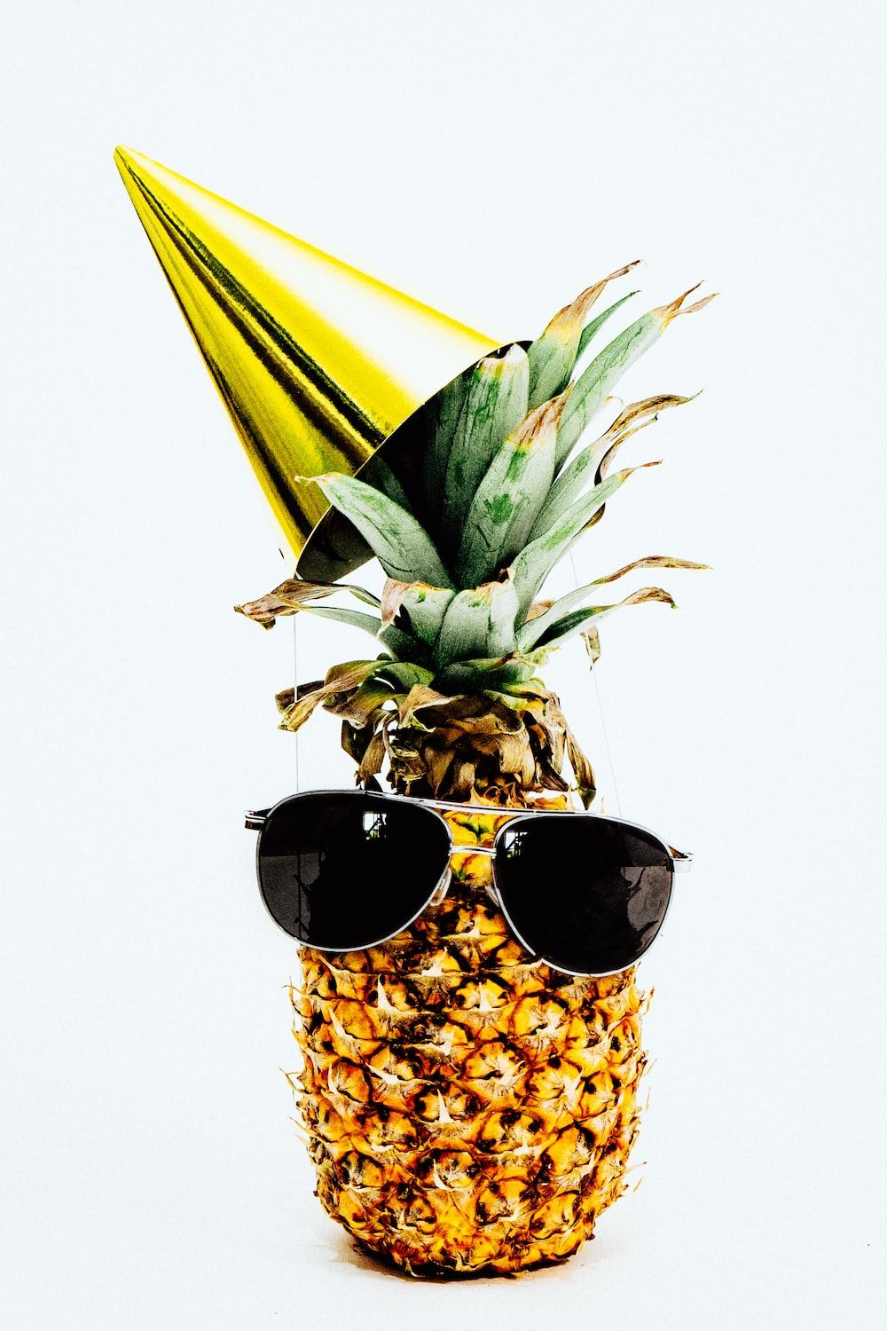 Pineapple wearing sunglasses and a party hat - Pineapple